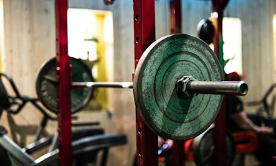 Public F2F listing photo showing a barbell station and weight plate